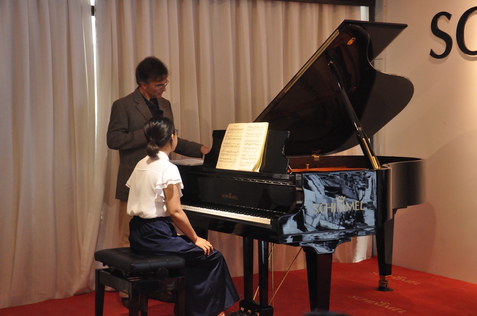 Vovka Ashkenazy teaching beside a pianist at a grand piano