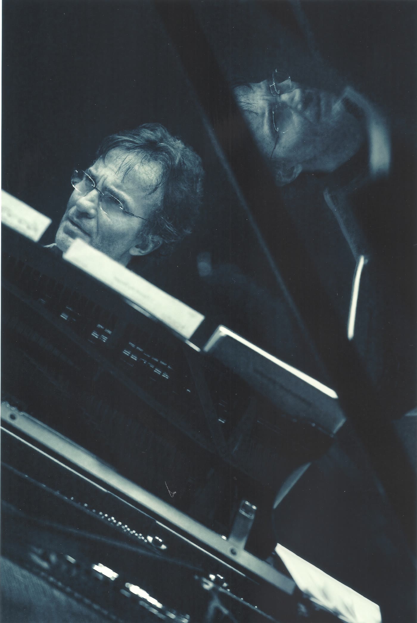 Artistic portrait of Vovka Ashkenazy at the piano, his face reflected in the raised lid